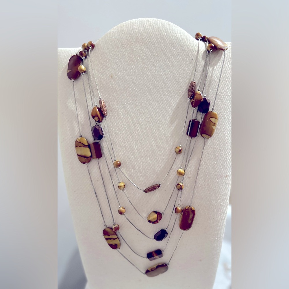Boutique 5 strand necklace of glazed petrified wood and copper on silver chains.
